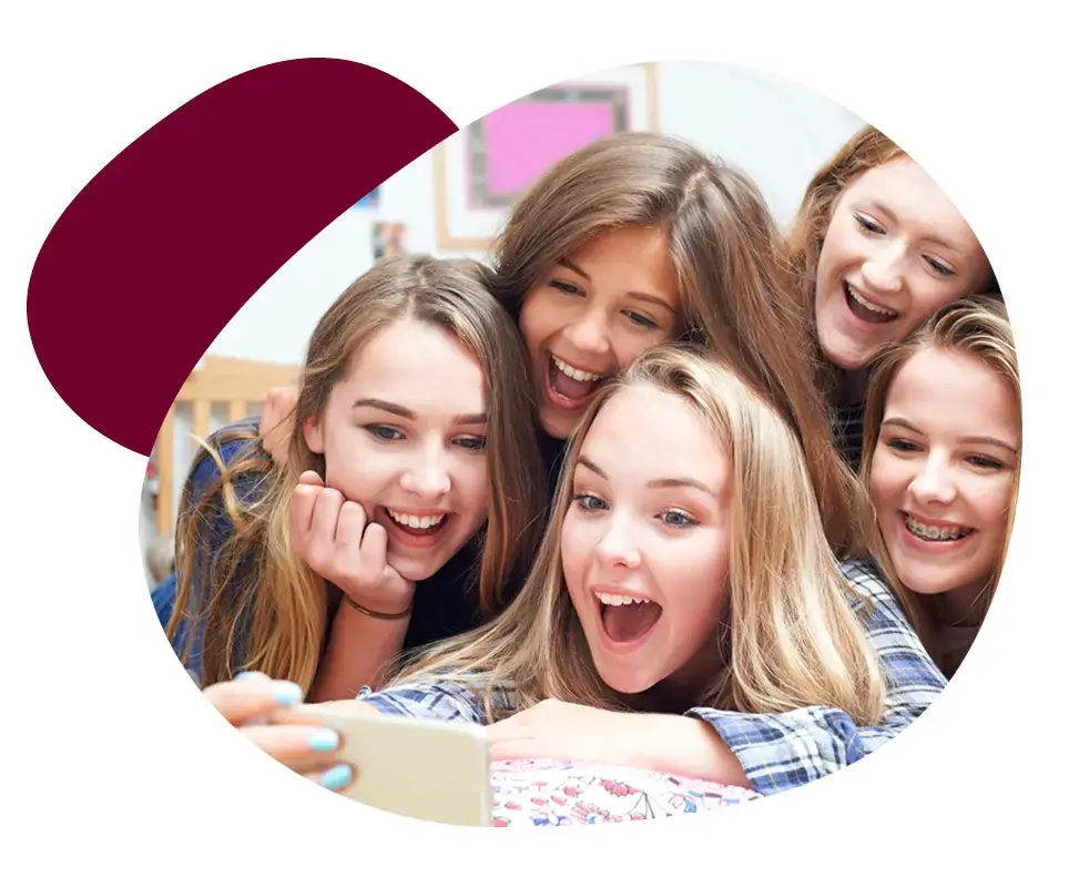 A group of girls smiling and taking a selfie with a cell phone, promoting dental care awareness through their bright smiles. A group of girls smiling and taking a selfie with a cell phone, promoting dental care awareness through their bright smiles.